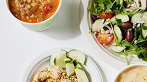 overhead view of salad plate and cups of soup