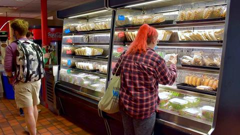 student getting to-go food from Memorial Hall Fly By
