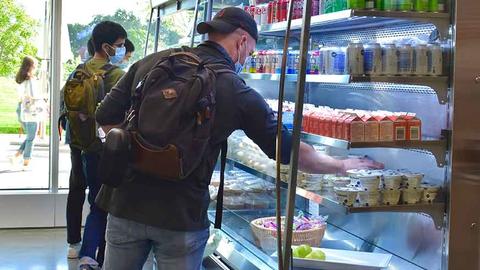 student getting to-go food from SEC Fly By