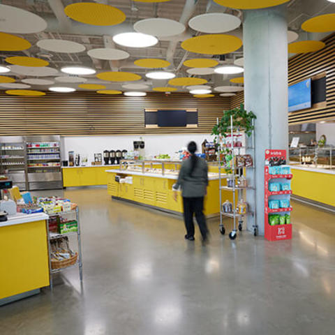 interior shot of cafe servery with salad bar island and various stations