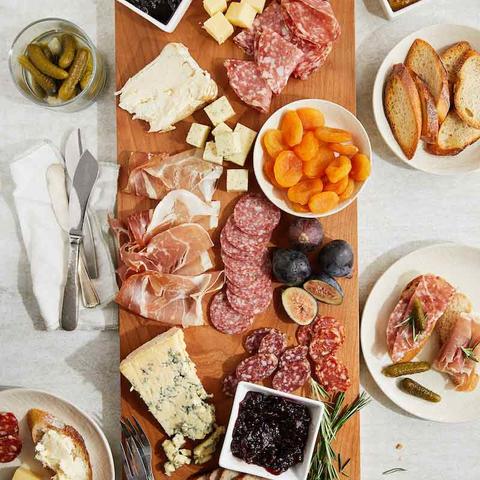 artfully arranged charcuterie board with cheeses, meats, dried fruits