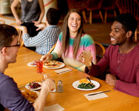 undergraduates at table dining together